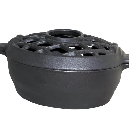 A black matte finish lattice steamer made of cast iron, designed for use with a wood or coal stove.